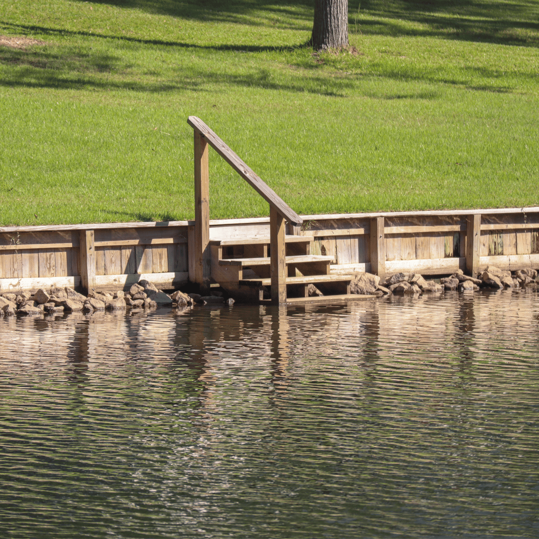 Submerged stairs in the water featuring an armrest for safety and support.