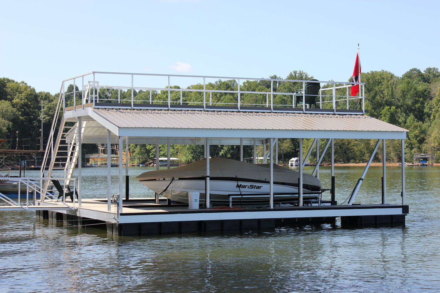 A serene lake dock with a boat being lifted, harmonizing functionality and natural beauty.